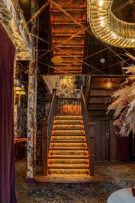 a set of stairs in a room with a ceiling at Charmante Skostredet Hôtel in Bergen
