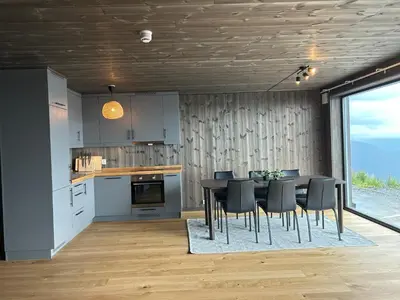 a kitchen and dining room with a table and chairs at Ny leilighet på Norefjell - ski in/out in Noresund