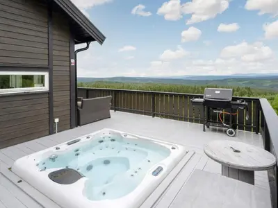 a hot tub on the deck of a house at 4 star holiday home in Fall-By Traum in Raufoss