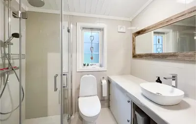 a bathroom with a toilet and a sink and a shower at Beautiful Home In Sjusjøen With Kitchen in Sjusjøen