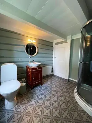 a bathroom with a toilet and a sink at Draget gård, historisk våningshus ved sjøen, rett utenfor Molde in Molde