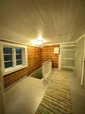 a room with a hallway with a rug and a window at Draget gård, historisk våningshus ved sjøen, rett utenfor Molde in Molde