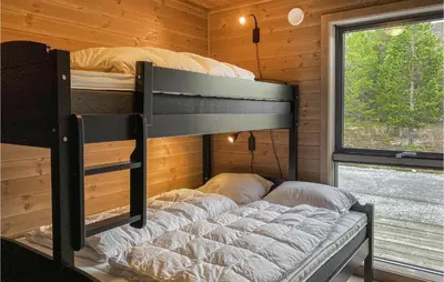 a bedroom with two bunk beds in a cabin at 4 Bedroom Nice Home In Bjorli in Bjorli
