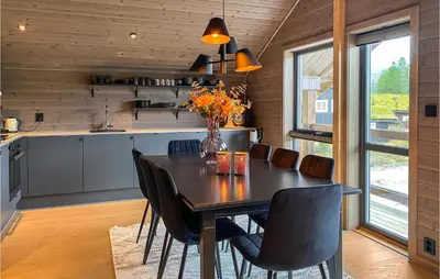 a kitchen and dining room with a table and chairs at 4 Bedroom Nice Home In Bjorli in Bjorli