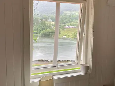 a window with a view of a river at 6 person holiday home in Bjoa-By Traum in Utbjoa