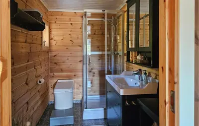 a bathroom with a shower and a toilet and a sink at Awesome Home In Hjartdal With Kitchen in Hjartdal