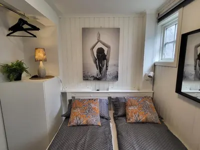 a living room with two beds and a table at Mars Modern and Cozy Apartment in the centre, Free Parking in Trondheim