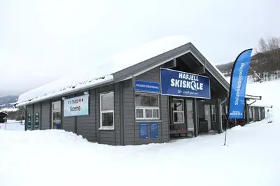 a building with a sign in the snow at Hafjelltunet in Hafjell