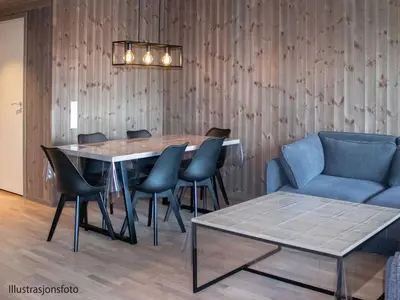 a dining room with a table and chairs and a couch at Hafjelltunet in Hafjell