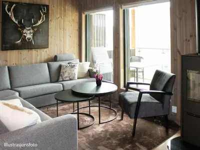 a living room with a couch and a table and chairs at Hafjelltunet in Hafjell