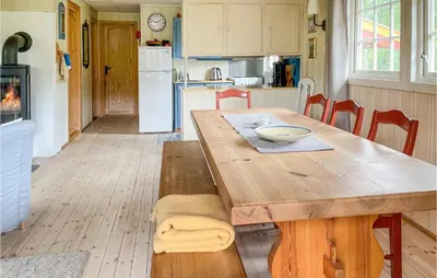 a kitchen with a wooden table and a dining room at Lovely Home In Eggedal With Wifi in Eggedal