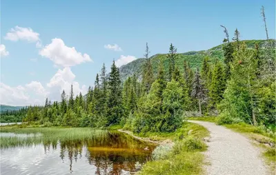 a path next to a lake in the mountains at Lovely Home In Eggedal With Wifi in Eggedal