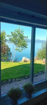 a window with a view of the water at Apartment by the fjord in Storekra