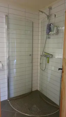 a bathroom with a shower with a glass door at Hallingstue by Hallstensgaard - Geilo in Geilo