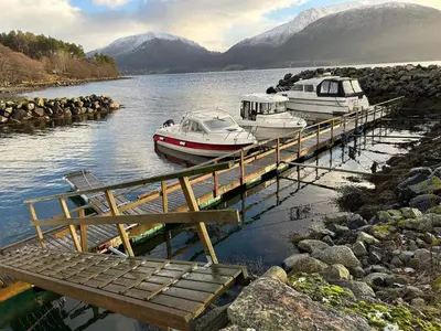 two boats are docked at a dock in the water at 6 person holiday home in AVERØY-By Traum in Stein