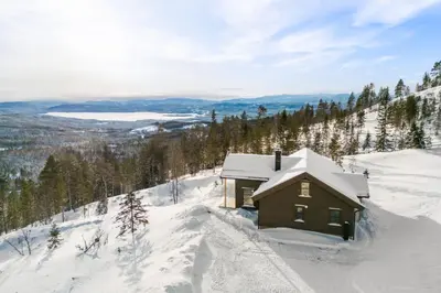 a cabin in the snow on a snowy mountain at Polaren by Norgesbooking - cabin with amazing view in Notodden