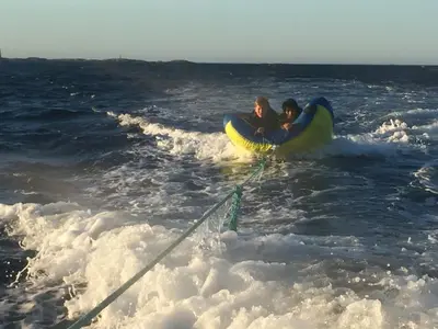 two people riding on a raft in the ocean at Atlantic Road Seaside Housing in Averoy