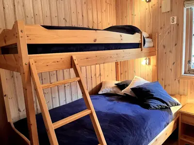 a bedroom with two bunk beds in a cabin at Skarsnuten Fjellandsby 23, Hemsedal, Ski-in/out in Hemsedal