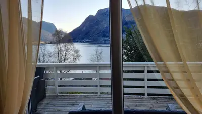 a view of a lake from a window at Feriehus Voldstad in Syvde