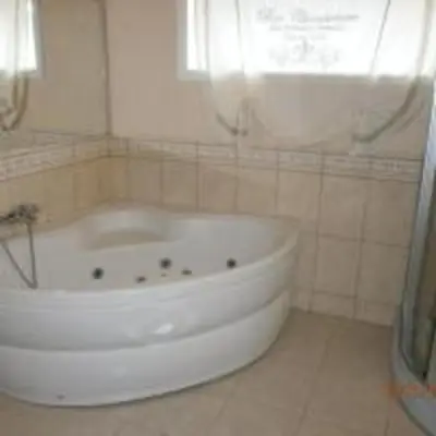 a white bath tub in a bathroom with a window at Feriehus Voldstad in Syvde