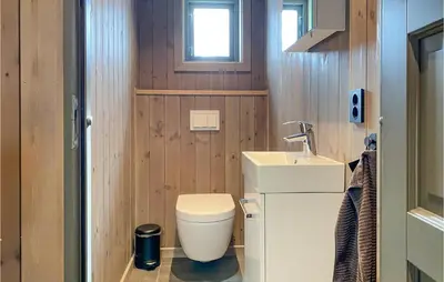 a small bathroom with a toilet and a sink at Cozy Home In Bjorli With Wifi in Bjorli