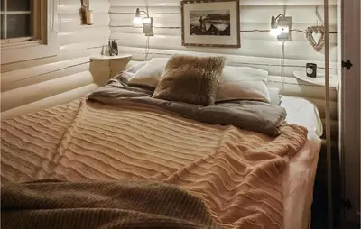 a bed in a room with white walls at Beautiful Home In Bjorli in Bjorli