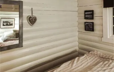 a bedroom with a wall of wood paneling at Beautiful Home In Bjorli in Bjorli