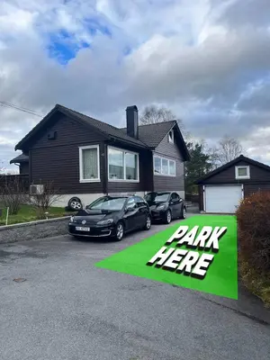 a parking here sign in front of a house at A Cozy Place To Stay Over in Tysvær