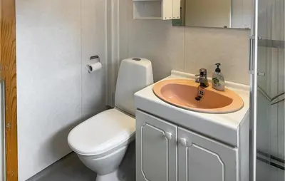 a bathroom with a toilet and a sink at Stunning Home In Verma With Kitchen in Bjorli