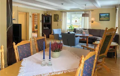 a dining room and living room with a table at Stunning Home In Verma With Kitchen in Bjorli