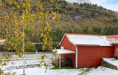 a red barn with snow on top of it at Stunning Home In Verma With Kitchen in Bjorli