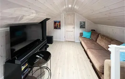 a living room with a couch and a flat screen tv at 4 Bedroom Lovely Home In Lillehammer in Lillehammer