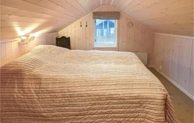 a large bed in a small room with a window at 4 Bedroom Lovely Home In Lillehammer in Lillehammer
