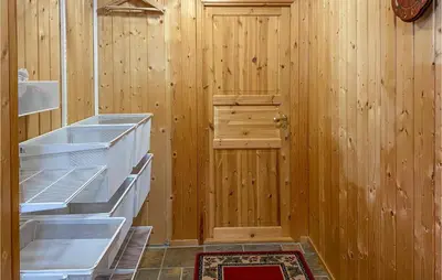 a kitchen with wooden walls and a wooden door at 3 Bedroom Nice Home In Bjorli in Bjorli