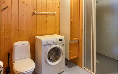 a bathroom with a washing machine and a toilet at 3 Bedroom Nice Home In Bjorli in Bjorli