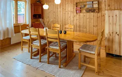 a wooden dining table and chairs in a room at 3 Bedroom Nice Home In Bjorli in Bjorli