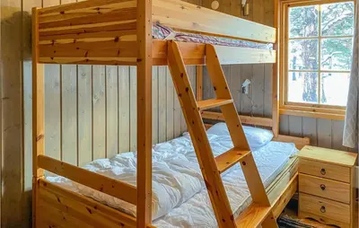 a bunk bed in a cabin with a ladder at 3 Bedroom Nice Home In Bjorli in Bjorli