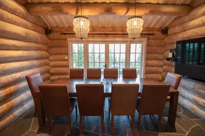 a dining room with a large wooden table and chairs at Chalet De Luxe 518 in Trysil