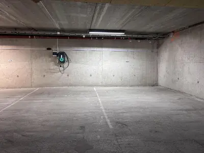 an empty parking garage with a green light on the wall at Mailatunet - Vestlia resort in Geilo