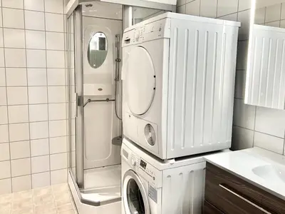 a white laundry room with a washer and dryer at Mailatunet - Vestlia resort in Geilo