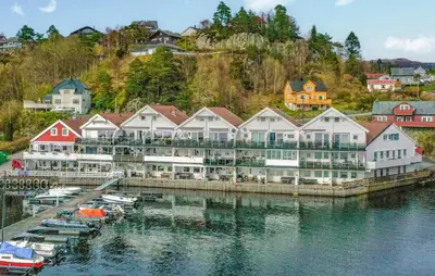 a group of buildings next to a body of water at Cozy Apartment In Uggdal With Wifi in Uggdal
