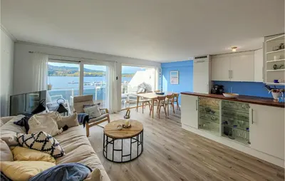 a living room with a couch and a table at Cozy Apartment In Uggdal With Wifi in Uggdal