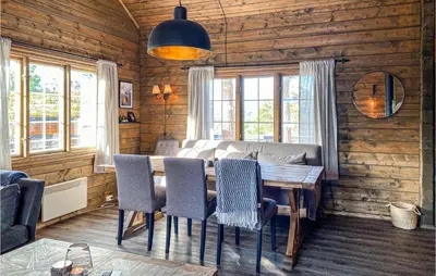 a dining room with a wooden table and chairs at Gorgeous Home In Bjorli With Wifi in Bjorli