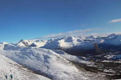 two people standing on top of a snow covered mountain at Kavli gjestehus - Isfjorden. in Isfjorden