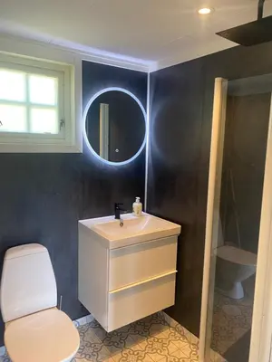 a bathroom with a sink and a toilet and a mirror at Nygård Camping in Hjelle