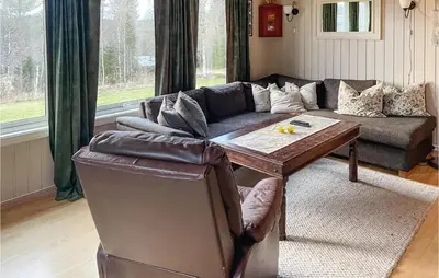 a living room with a couch and a table at Cozy Home In Østby With Wifi in Trysil