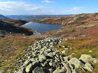 a large group of rocks on a hill with a lake at Cabin with a great view at Gaustablikk in Gaustablikk