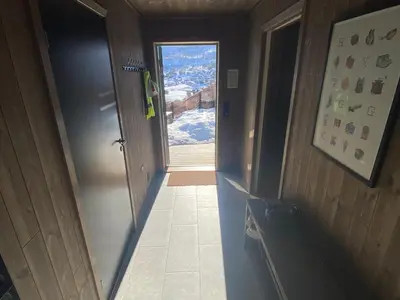 a hallway with a door to a room with a window at Moderne hytte i Svandalen, Sauda - nær skisenter og natur in Sauda