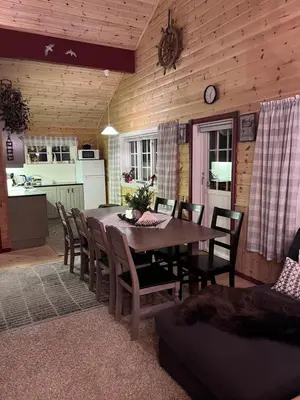 a kitchen and dining room with a table and chairs at Domek Iwony in Molde