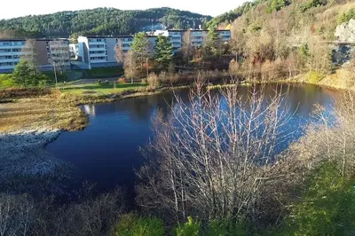 an aerial view of a lake in front of a building at Your Dream Studio in Bergen in Bergen
